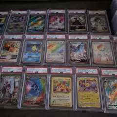 A collection of graded Pokémon cards, including Charizard, Mewtwo, and Pikachu, displayed in protective cases.