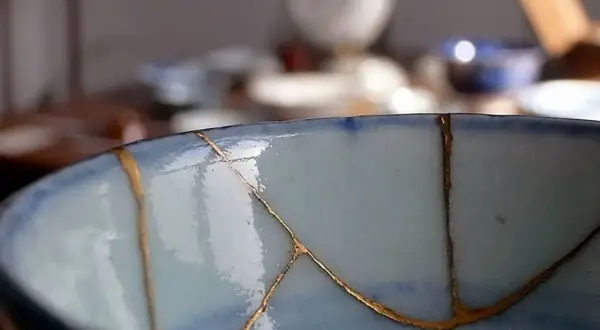Il kintsugi come fare: riparare una ciotola con oro, valorizzando le crepe.