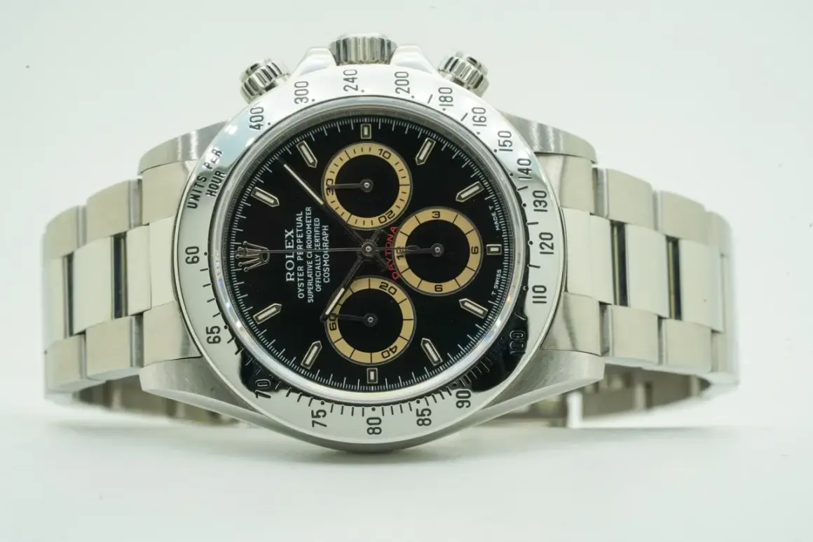 Rolex Daytona watch with black dial and tachymeter bezel.