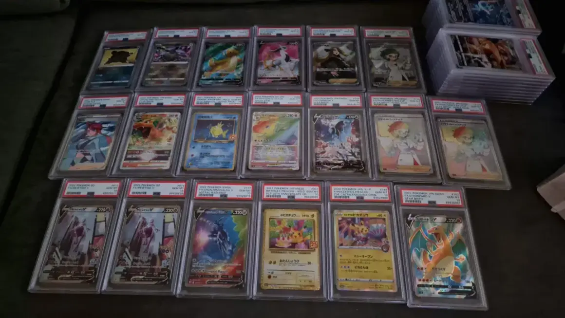 A collection of graded Pokémon cards, including Charizard, Mewtwo, and Pikachu, displayed in protective cases.