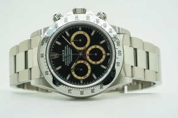 Rolex Daytona watch with black dial and tachymeter bezel.